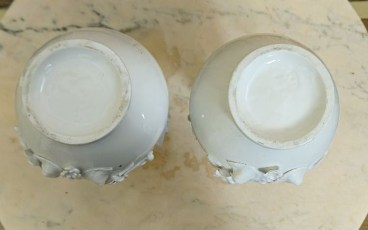 Pair of white porcelain vases with floral decoration in relief