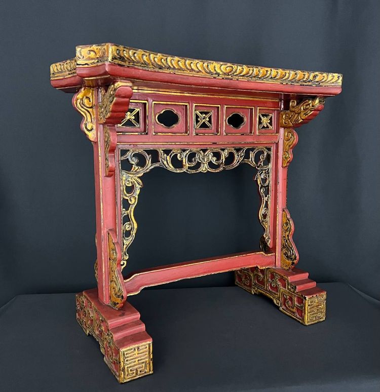Decorative Asian-style side table in red and gold lacquered wood