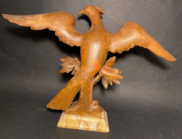 Early 19th century carved and gilded wooden eagle. Marble base.