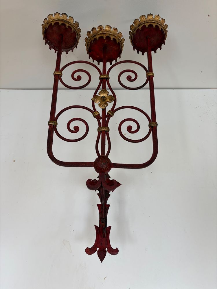 PAIR OF WROUGHT IRON CANDLE-SOCKET WALL LIGHTS, STAINED RED AND GOLD.