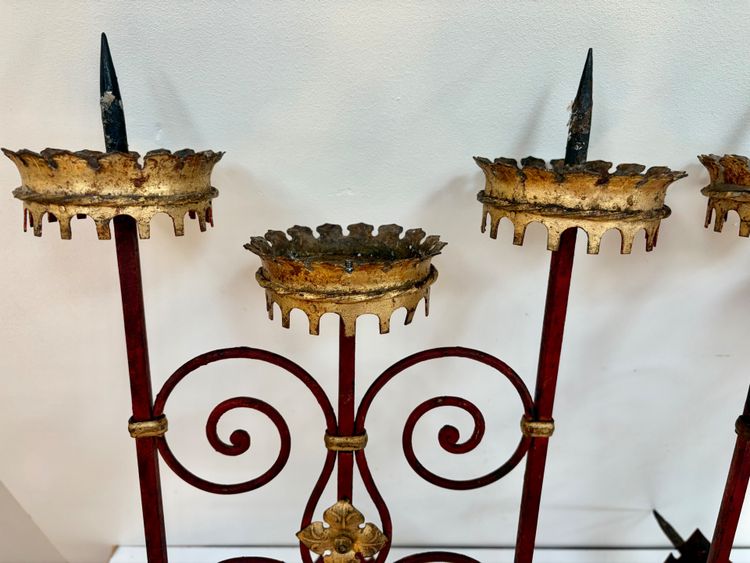 PAIR OF WROUGHT IRON CANDLE-SOCKET WALL LIGHTS, STAINED RED AND GOLD.
