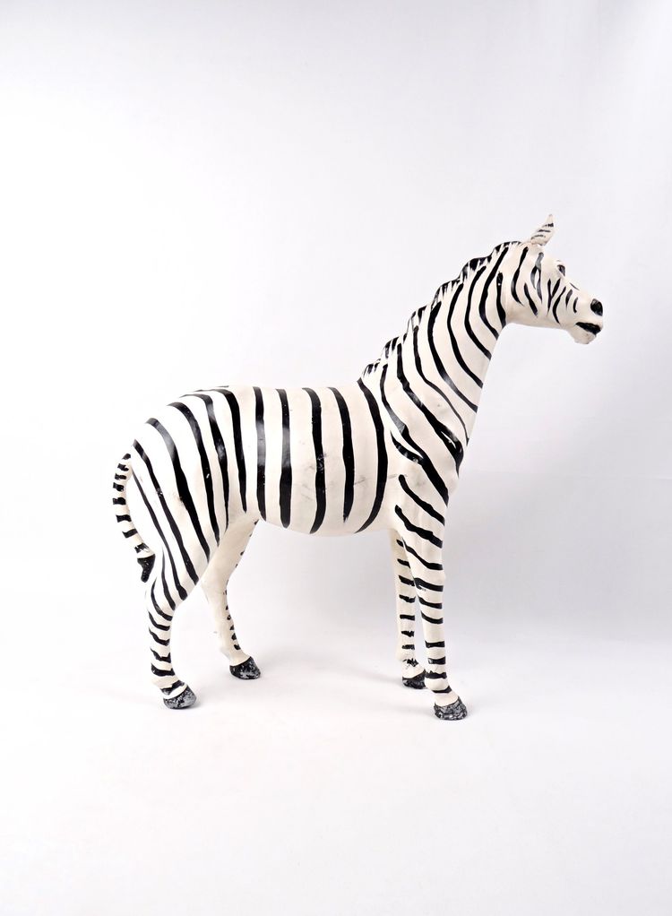 Scultura in cuoio dipinto raffigurante una zebra con occhi di vetro nero, Kenya, metà del XX secolo.
