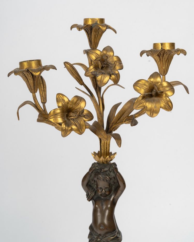 Pair of candelabra featuring putto figures, in patinated bronze and gilded bronze