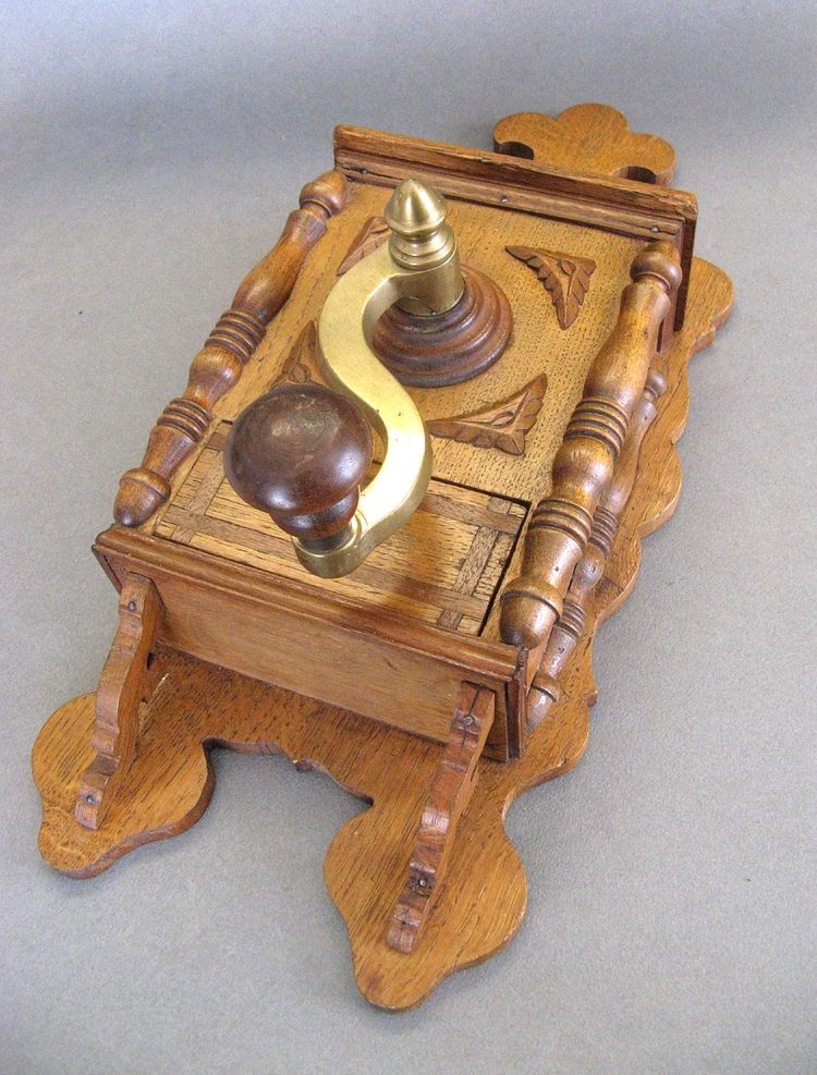 Large wall-mounted coffee grinder from a 19th-century pub.