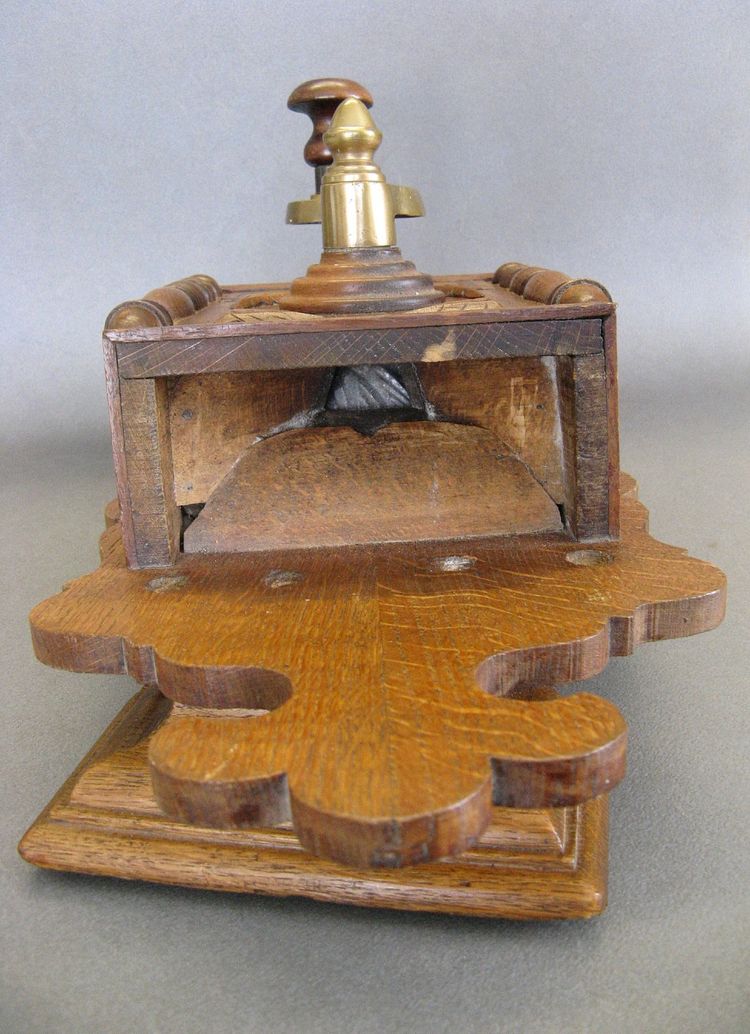 Large wall-mounted coffee grinder from a 19th-century pub.