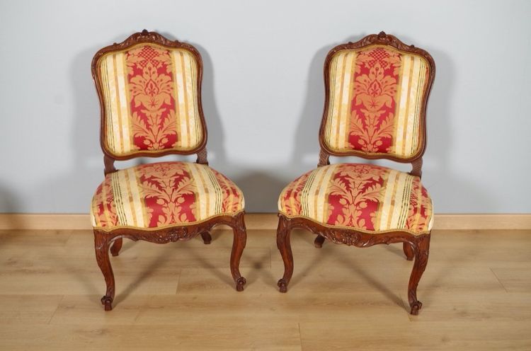 Set of four Regency-style chairs in carved walnut with flat backs, circa 1900