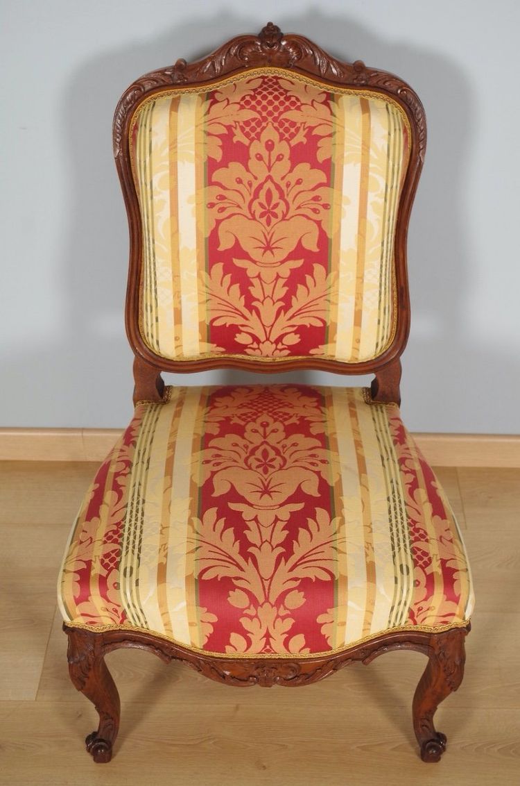 Set of four Regency-style chairs in carved walnut with flat backs, circa 1900