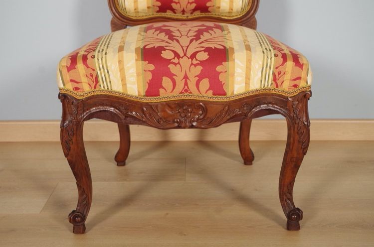 Set of four Regency-style chairs in carved walnut with flat backs, circa 1900
