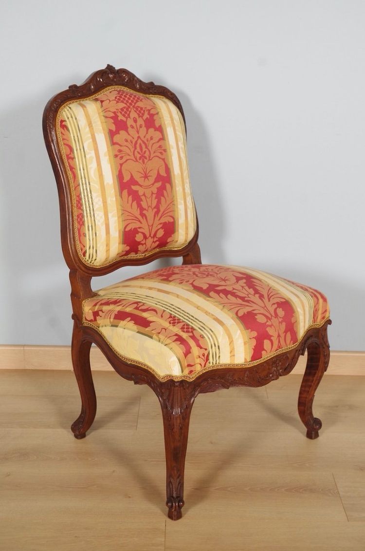 Set of four Regency-style chairs in carved walnut with flat backs, circa 1900