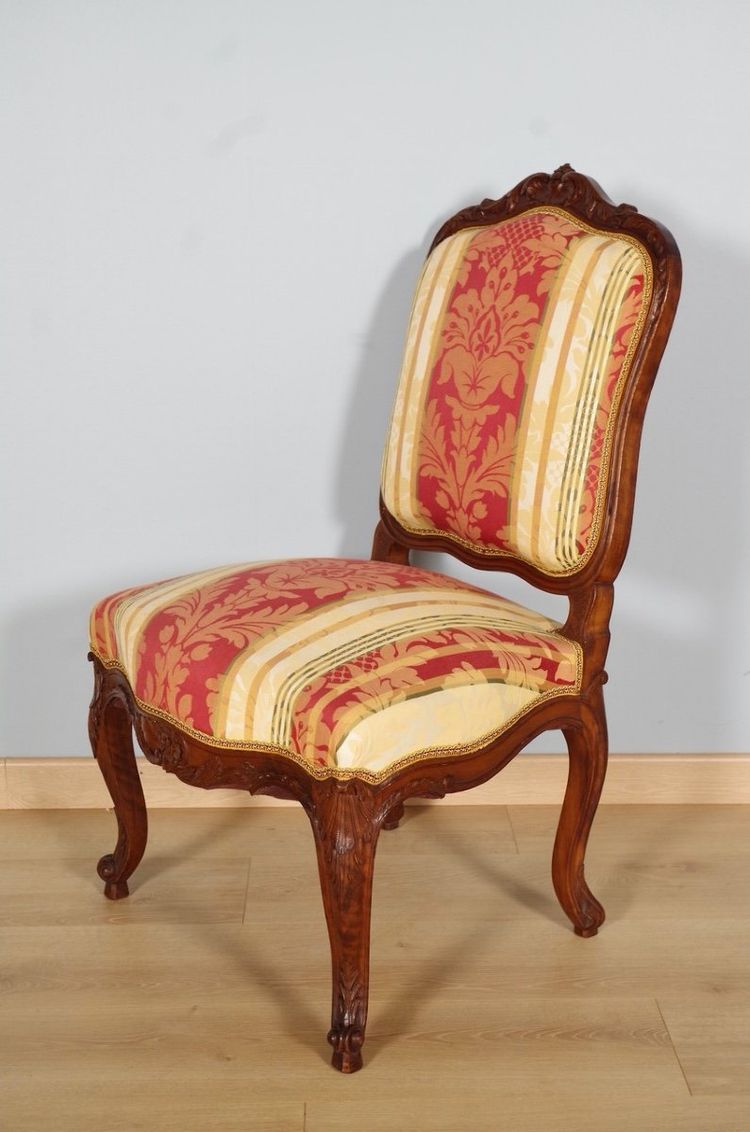Set of four Regency-style chairs in carved walnut with flat backs, circa 1900