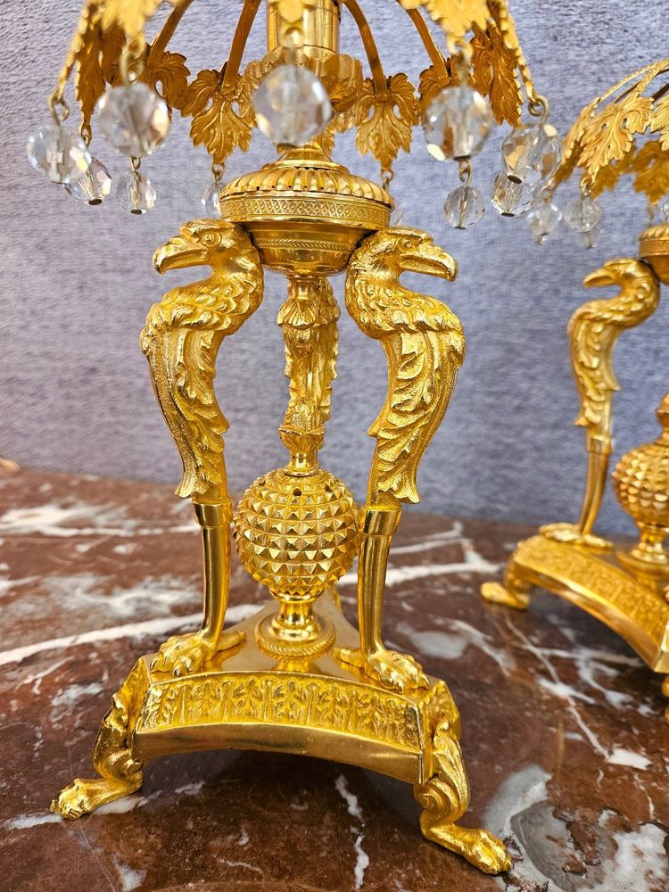 Pair of bronze candlesticks with eagles and tassels