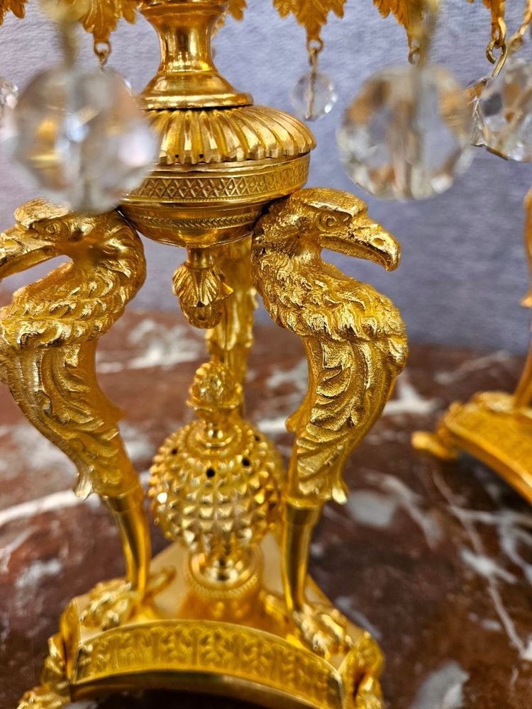 Pair of bronze candlesticks with eagles and tassels