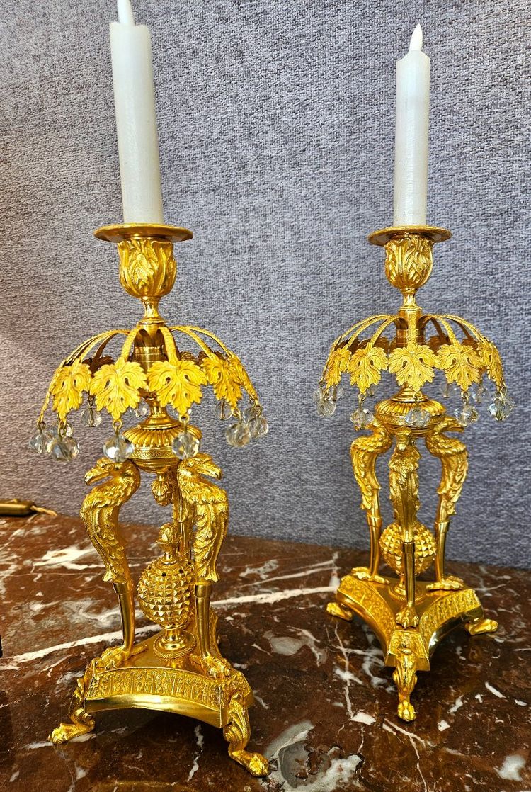 Pair of bronze candlesticks with eagles and tassels