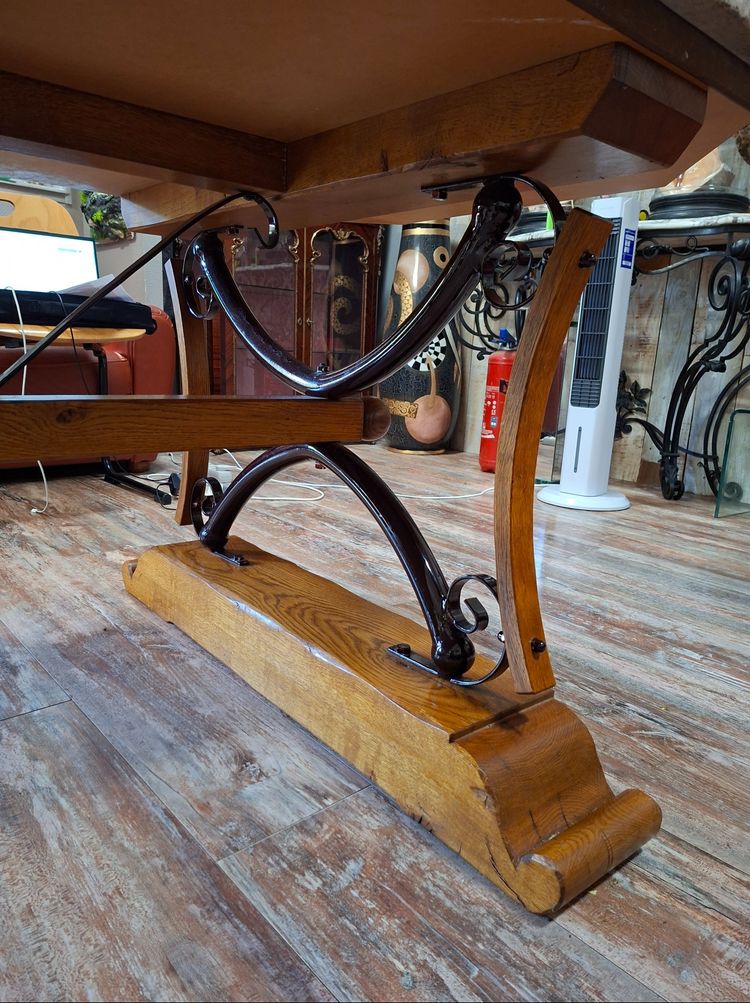 Large dining table made of polished granite with an oak and wrought-iron base 