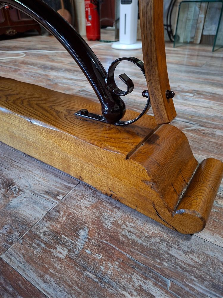 Large dining table made of polished granite with an oak and wrought-iron base 