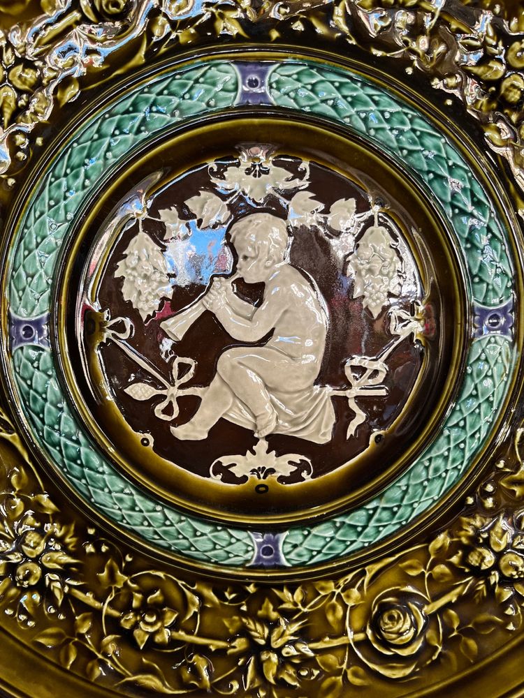 Large earthenware dish decorated with a flute player in the Renaissance style.