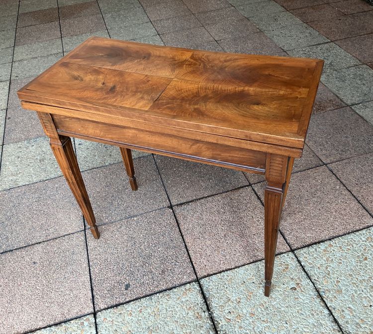 A Louis XVI-style eye table, made of walnut