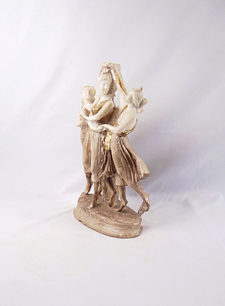Sculpture titled "The Three Graces," made of white and gold resin, 20th century