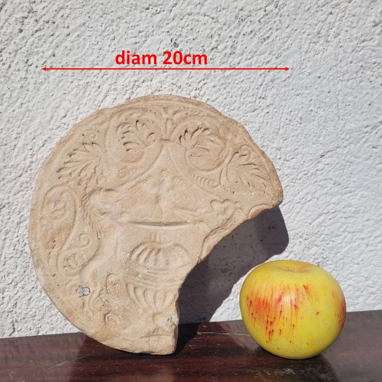 Round stone carved on each face, probably 17th century