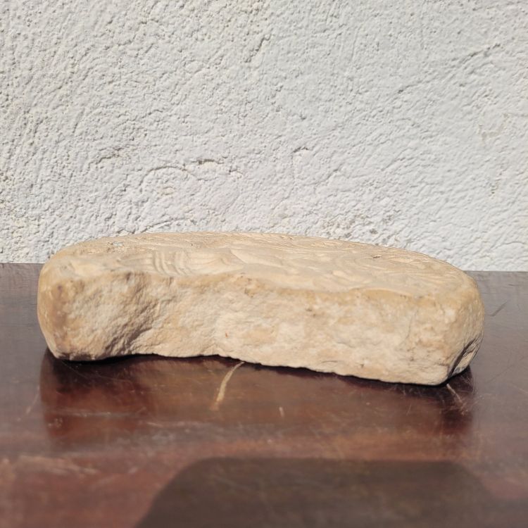 Round stone carved on each face, probably 17th century
