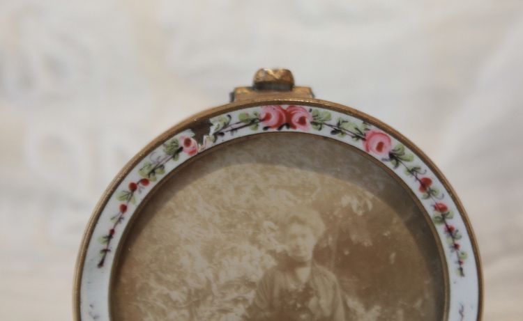 Circular enameled brass photo frame, circa 1900