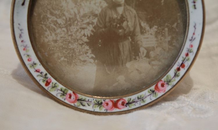 Circular enameled brass photo frame, circa 1900