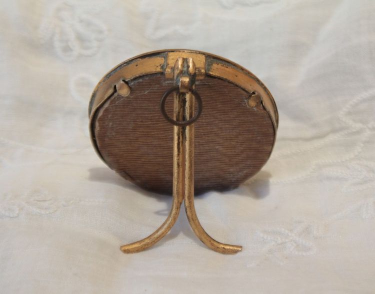 Circular enameled brass photo frame, circa 1900