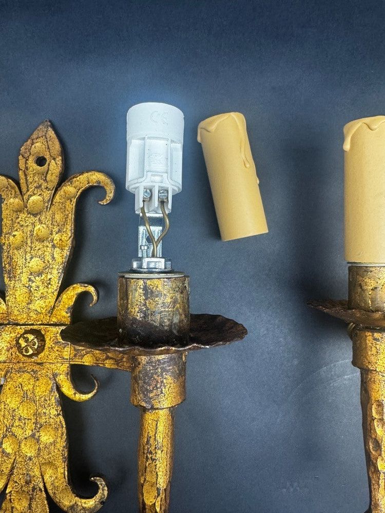 Pair of gilded wrought-iron Gothic wall sconces with built-in lighting