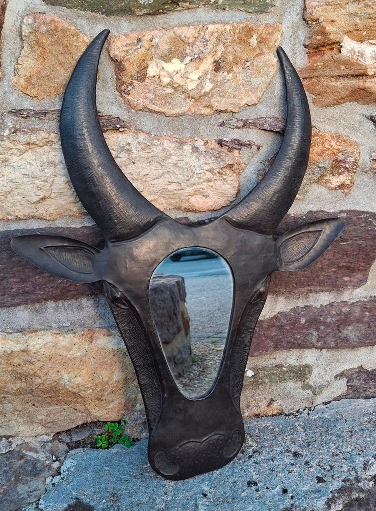 Metal mirror shaped like a cow's or bull's head