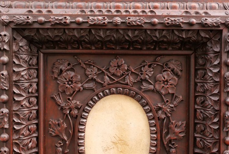 Richly carved, stained fruitwood oval picture frame, 19th century