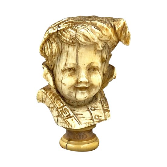 CANE KNOB carved in the round of a CHILD'S HEAD in costume