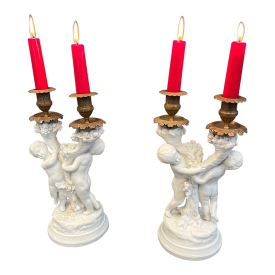 Pair of candlestick in cookie of Sevres with putti