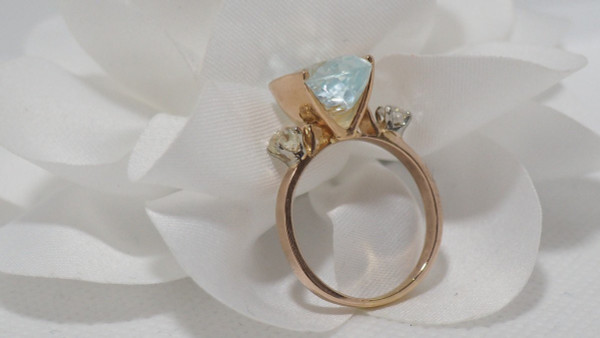 Rose Gold Ring Adorned With An Oval Aquamarine And Diamonds