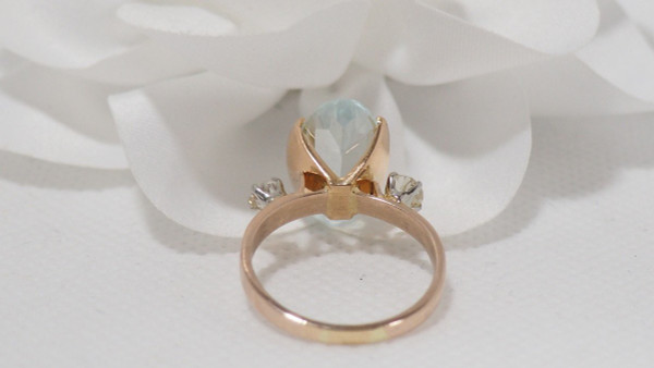 Rose Gold Ring Adorned With An Oval Aquamarine And Diamonds