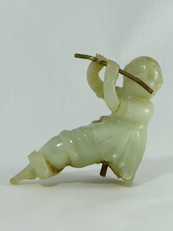 China Circa 1900, Jade Sculpture of a Child Playing the Flute.