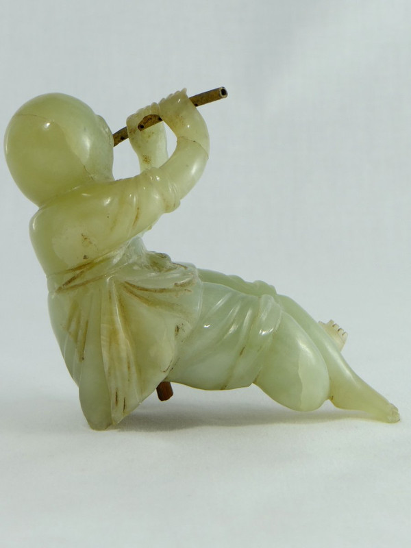 China Circa 1900, Jade Sculpture of a Child Playing the Flute.