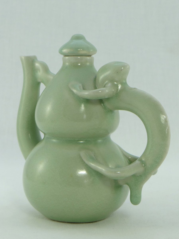 China, Mid-20th Century, Celadon porcelain teapot, two-lobed form.