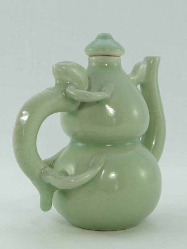 China, Mid-20th Century, Celadon porcelain teapot, two-lobed form.