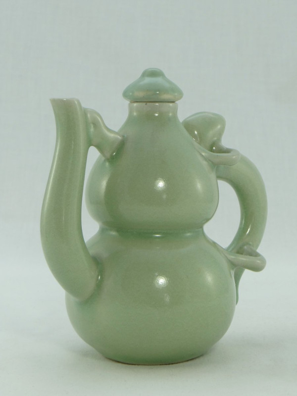 China, Mid-20th Century, Celadon porcelain teapot, two-lobed form.