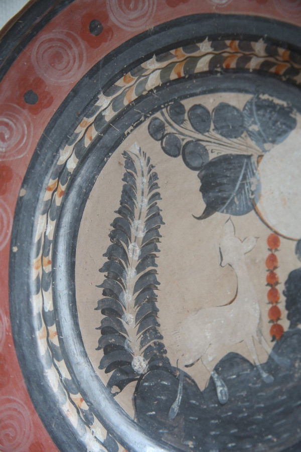 Grande piatto circolare in terracotta decorato con un cerbiatto in un paesaggio.