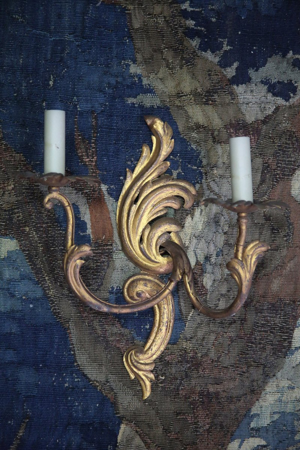 Suite of three gilded sheet metal sconces in the rocaille style.