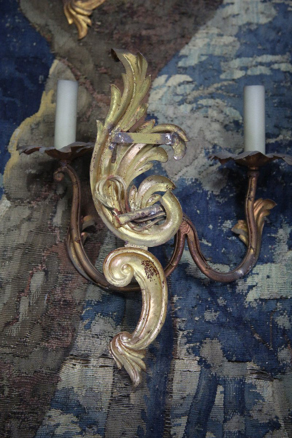 Suite of three gilded sheet metal sconces in the rocaille style.