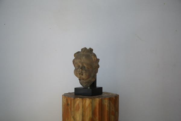Grey stoneware sculpture of a child's face, Netherlands, early 18th century.