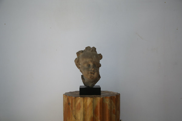 Grey stoneware sculpture of a child's face, Netherlands, early 18th century.