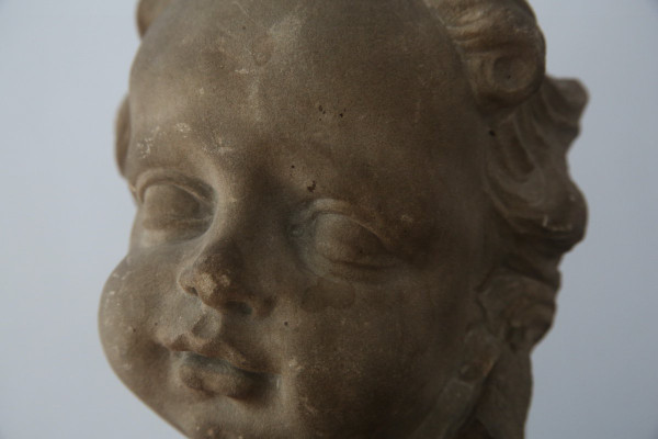 Grey stoneware sculpture of a child's face, Netherlands, early 18th century.