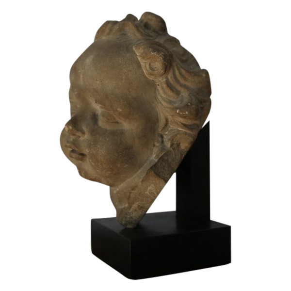 Grey stoneware sculpture of a child's face, Netherlands, early 18th century.