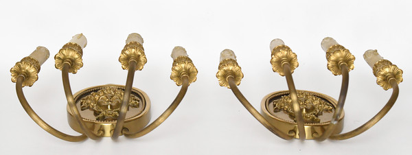 Pair of brass and gilded metal wall lights decorated with a Bacchus mask