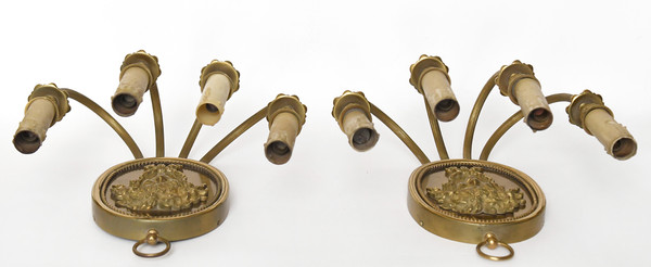 Pair of brass and gilded metal wall lights decorated with a Bacchus mask