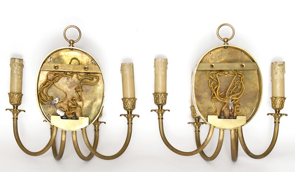 Pair of brass and gilded metal wall lights decorated with a Bacchus mask