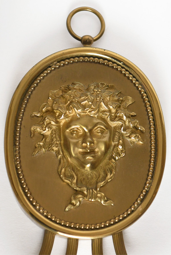 Pair of brass and gilded metal wall lights decorated with a Bacchus mask